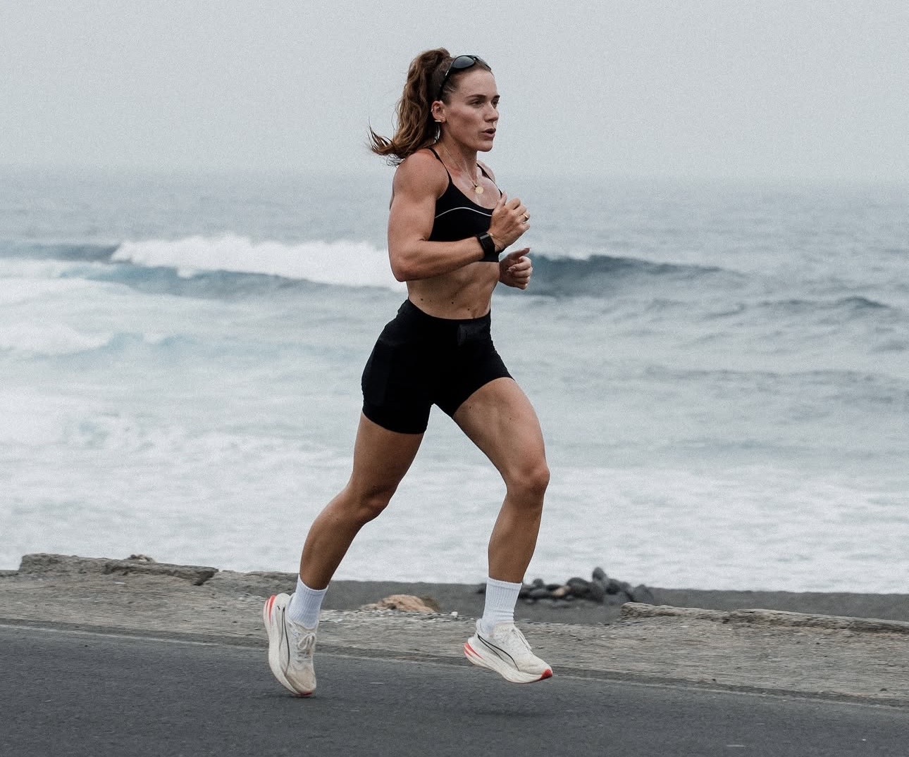 Lucy Davis running beside the sea